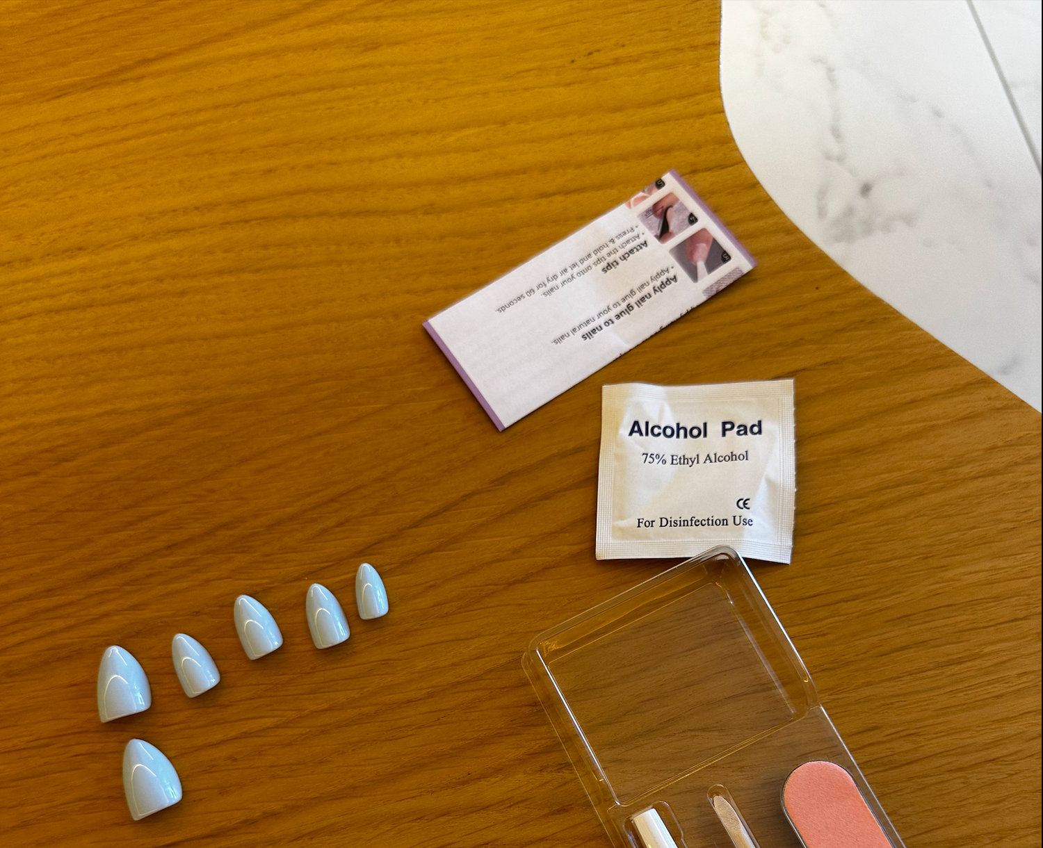 Applying neutral press-on nails at home for a natural, long-lasting look