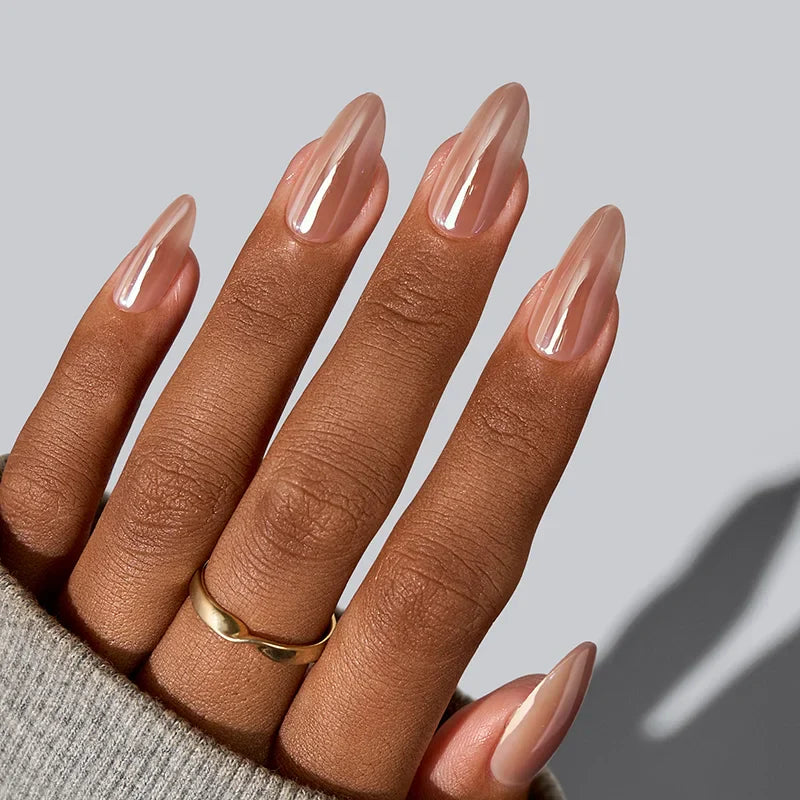 Hand with long, nude-colored nails on a gray background